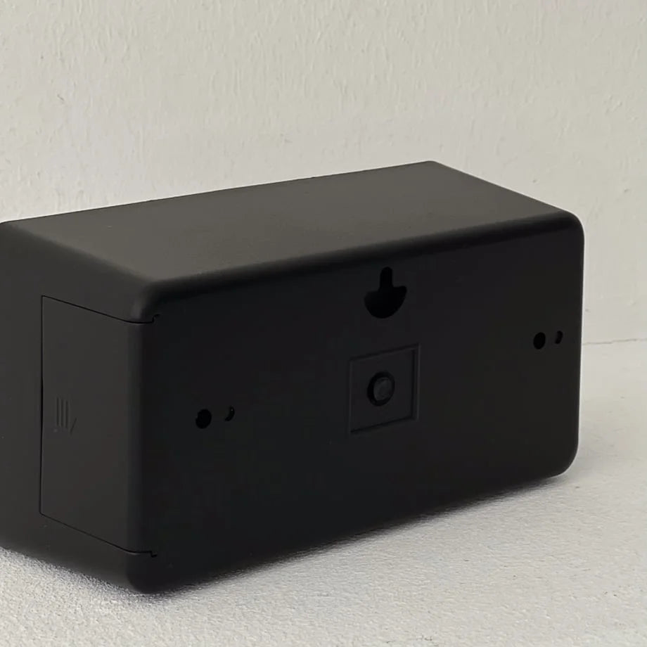 Back view of the black retro flip clock showing the wall mount hole and adjustment knob. - RoomDen