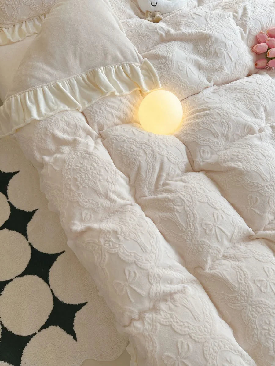 Top-down view of the puffy Creamy Beige duvet cover's texture next to a black and white rug - RoomDen.