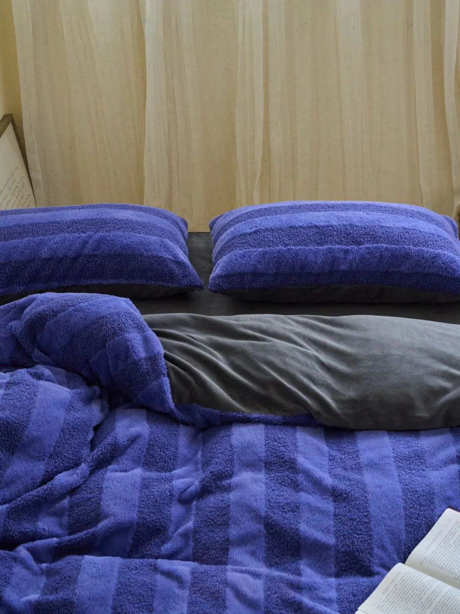 Close up of purple fuzzy striped texture on pillows and duvet cover - RoomDen
