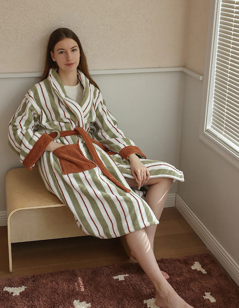 Model relaxed on a bench in the vintage-style sage and white striped robe — RoomDen