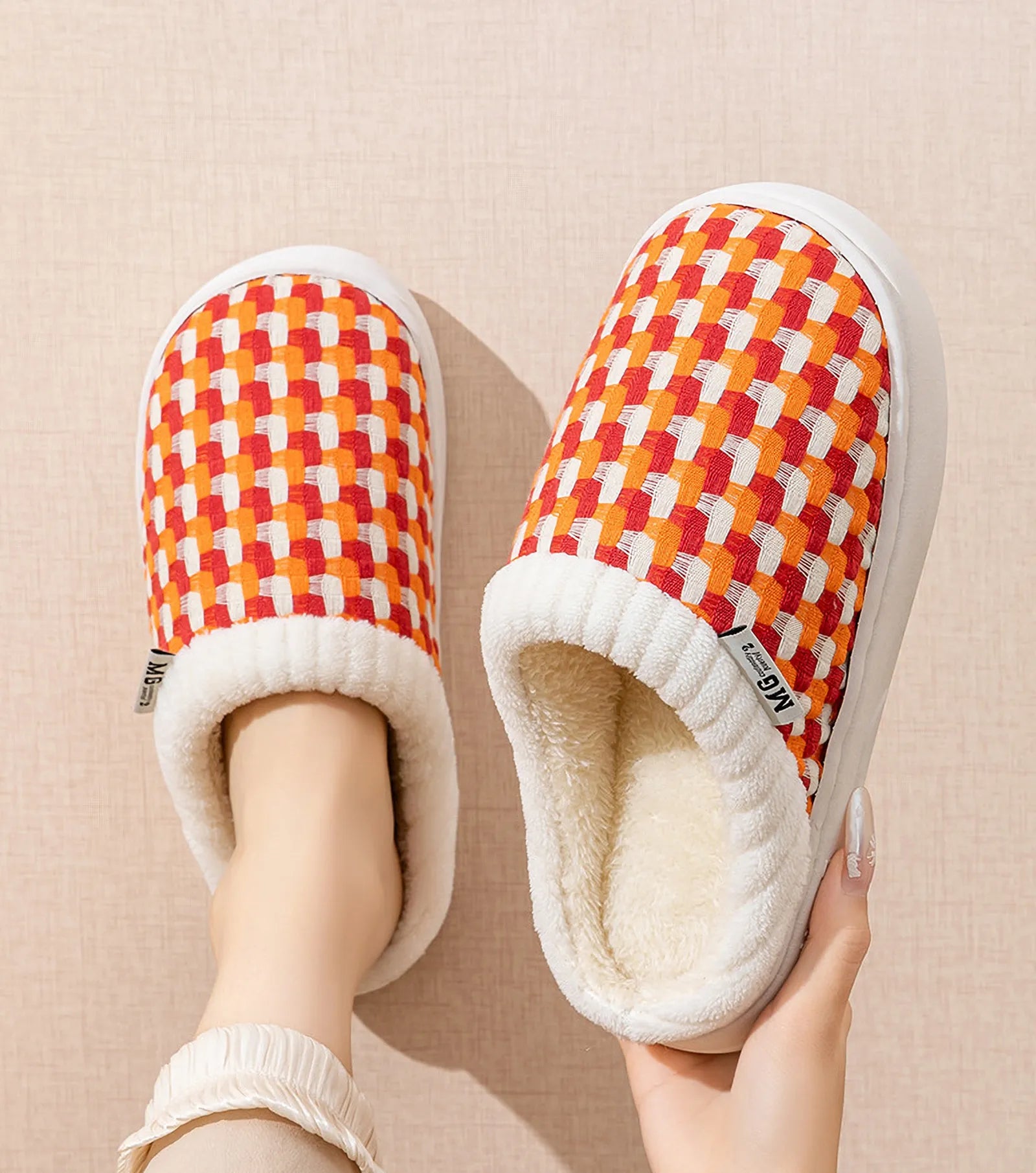 Top view of orange woven gingham slippers on feet showing plush collar - RoomDen