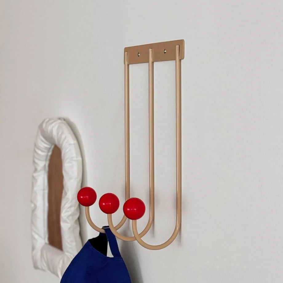 Detailed angle of the Beige & Red metal wall hooks, showing its smooth finish and vibrant red knobs. - RoomDen