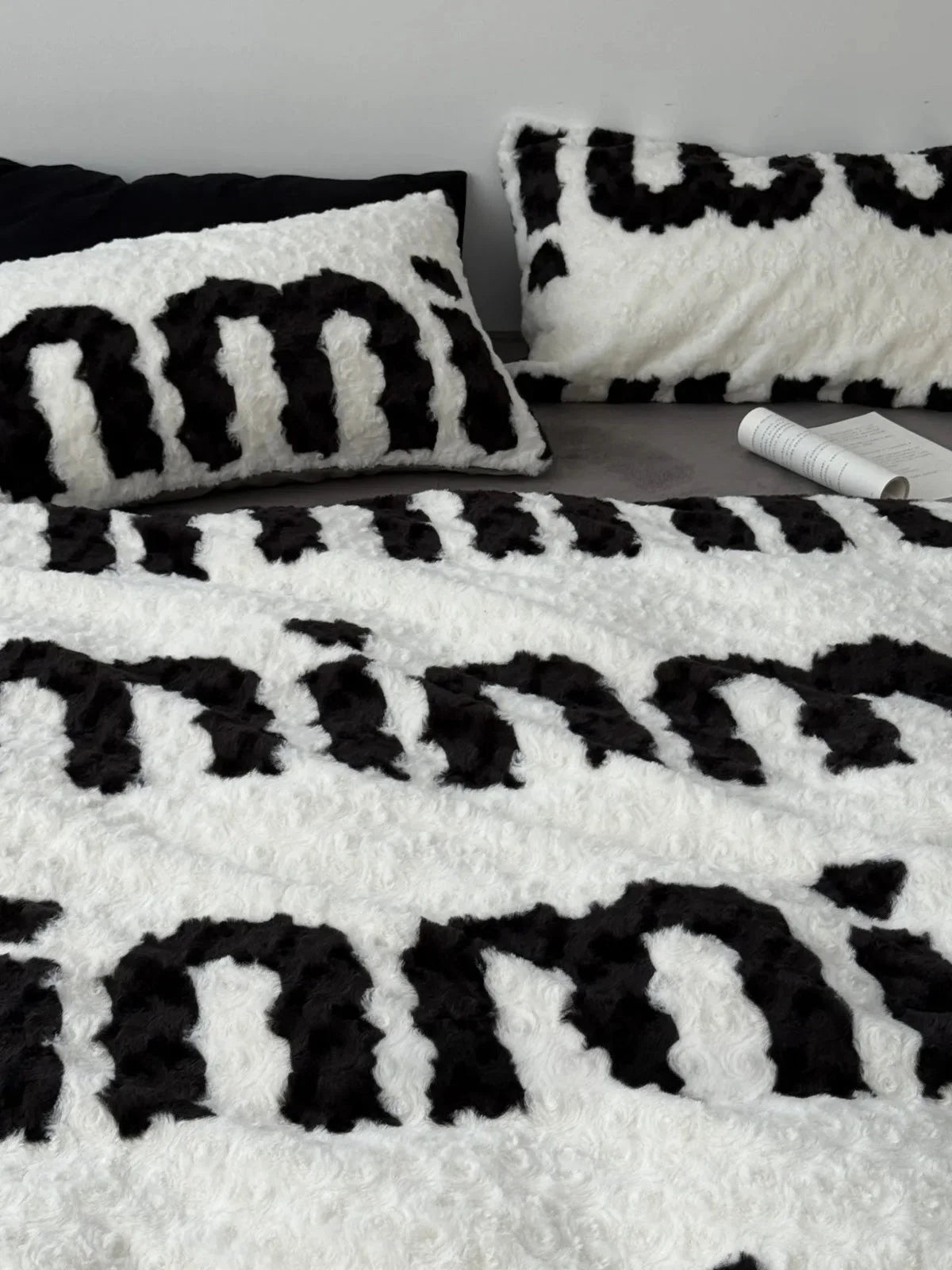 Top-down view showcasing the text pattern across the fuzzy flannel fleece duvet cover and matching pillowcases. - RoomDen