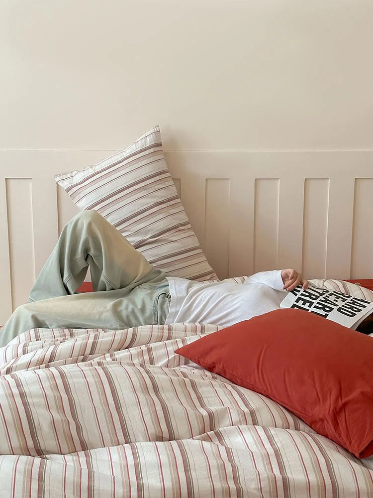 Lifestyle image showing the comfortable and relaxed feel of the Red Striped Washed Cotton Bedding. - RoomDen