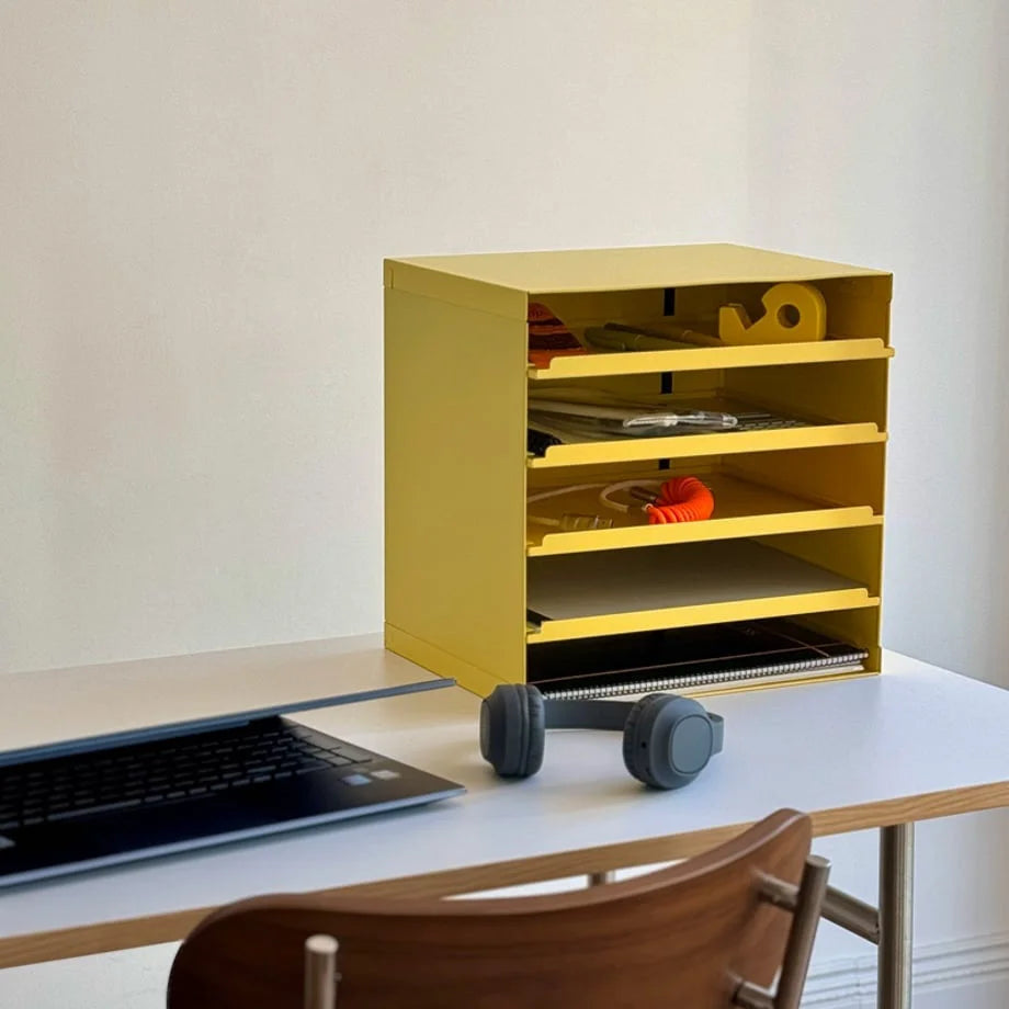 Sunny Yellow metal desktop organizer on a white desk with headphones and a laptop - RoomDen.