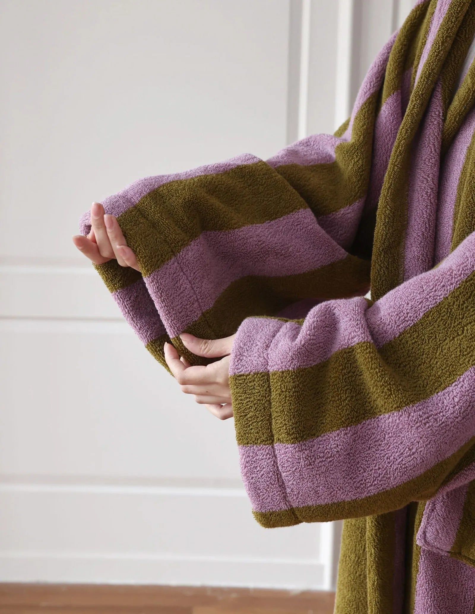 Detail shot of the wide sleeve cuff showing the plush loop texture of the cotton fabric.