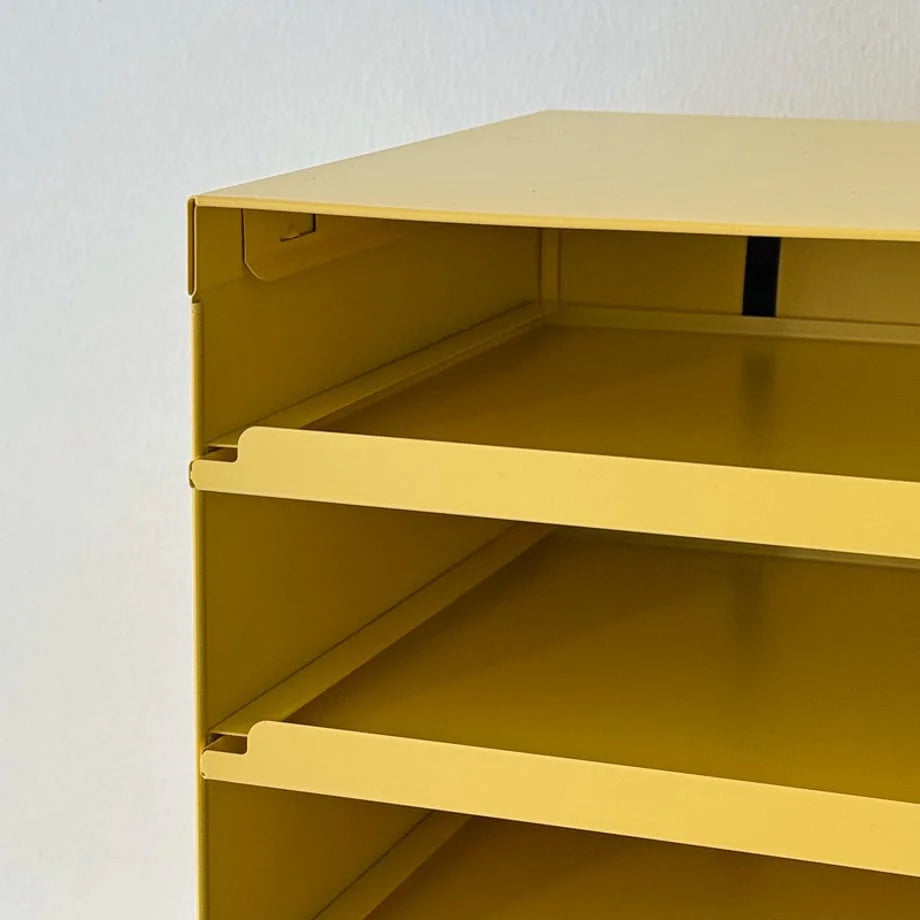 Close-up on the corner construction and shelf detail of the Sunny Yellow metal organizer - RoomDen.