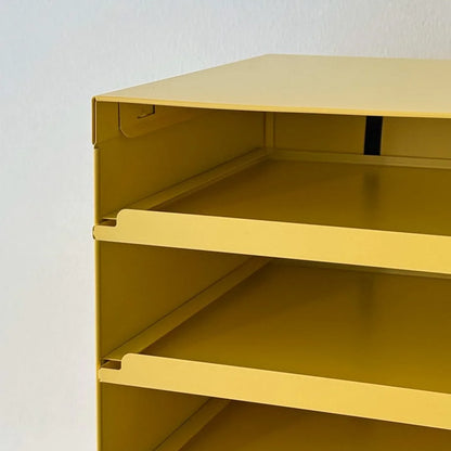 Close-up on the corner construction and shelf detail of the Sunny Yellow metal organizer - RoomDen.