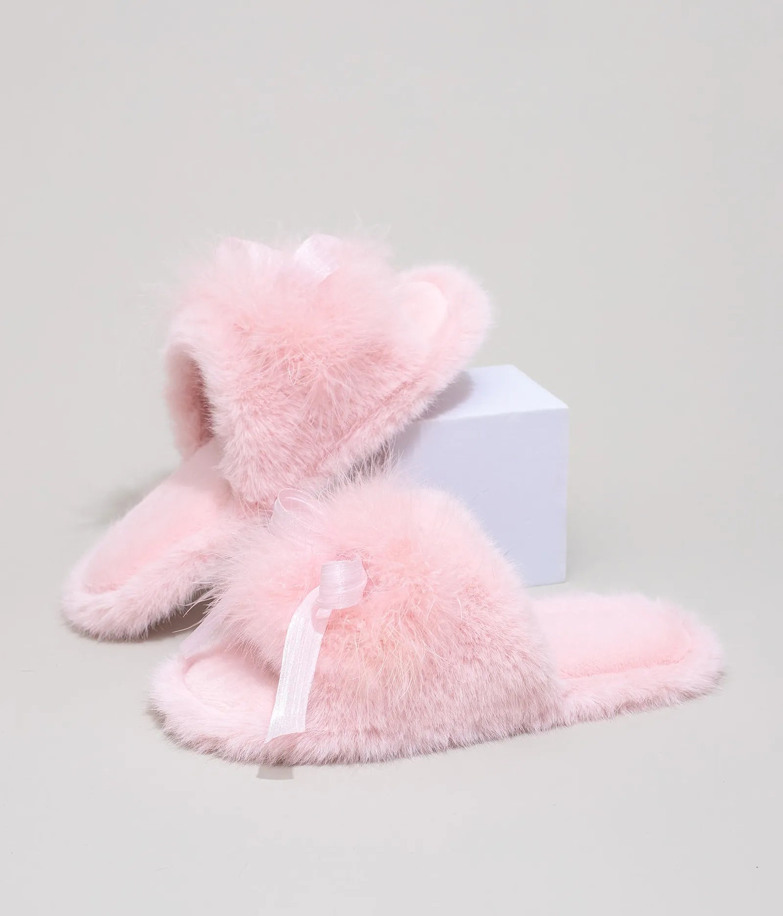 Side view of Baby Pink coquette style faux fur slippers showing plush texture
