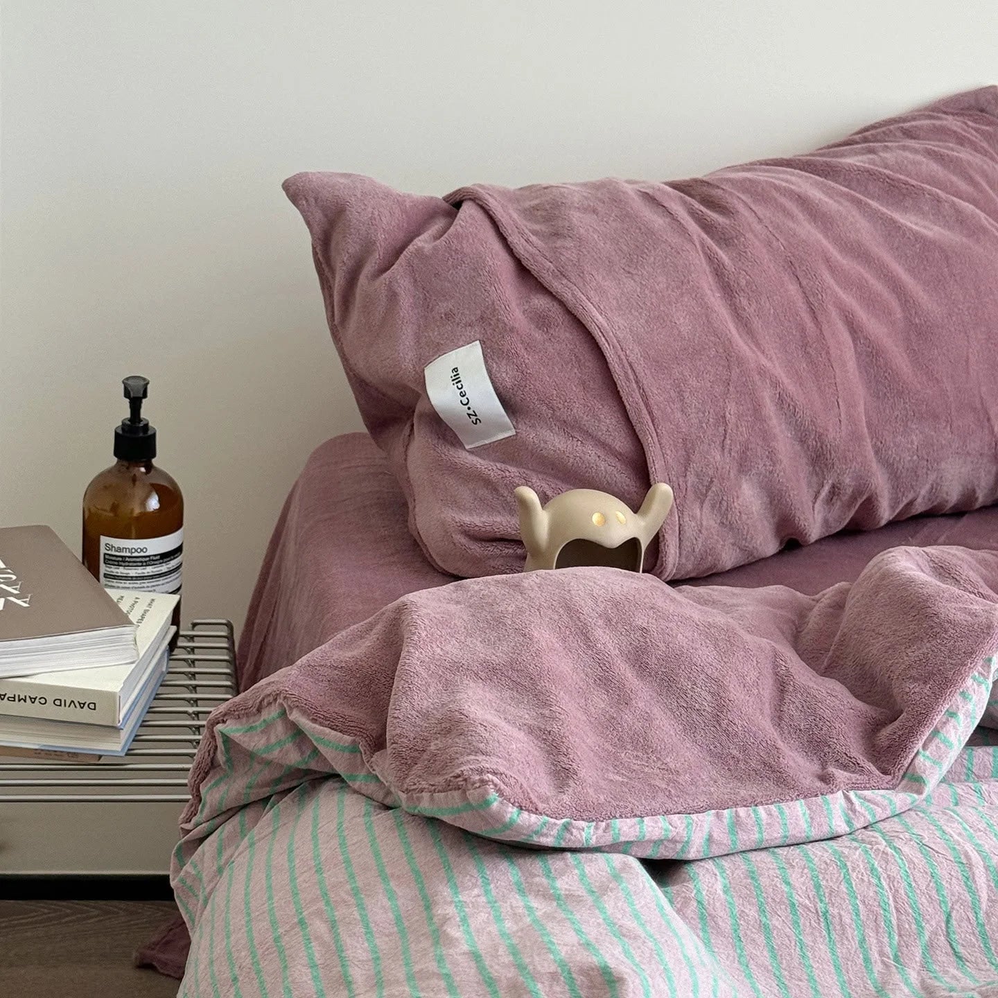 Angled shot of the Pink & Mint Striped bedding, highlighting its cozy and playful look.