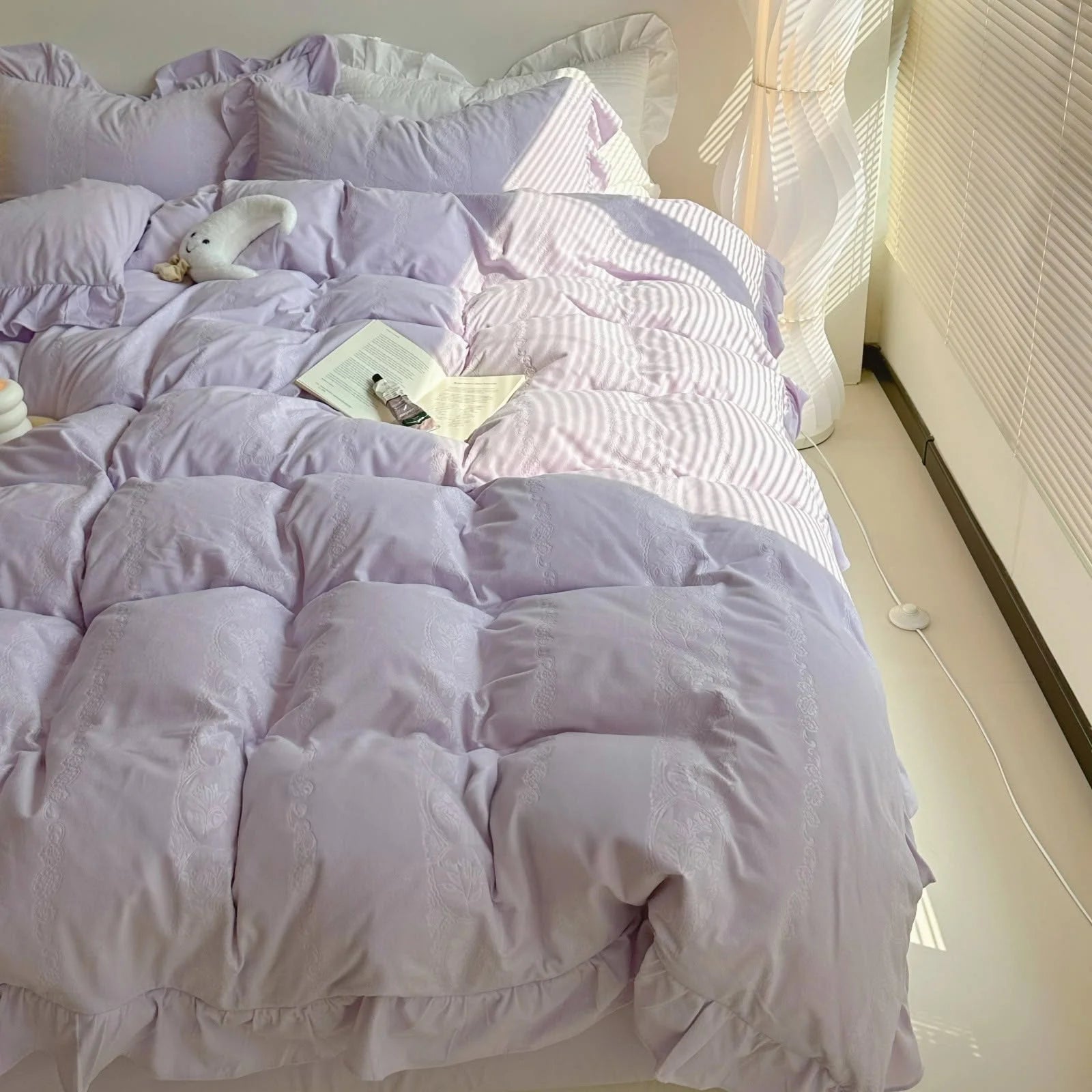 Overhead shot of the cozy Lavender Velvet Bedding Set with soft shadows from the window. - RoomDen