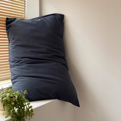 Soft washed cotton solid pillowcase in a minimalist cozy bedroom – RoomDen