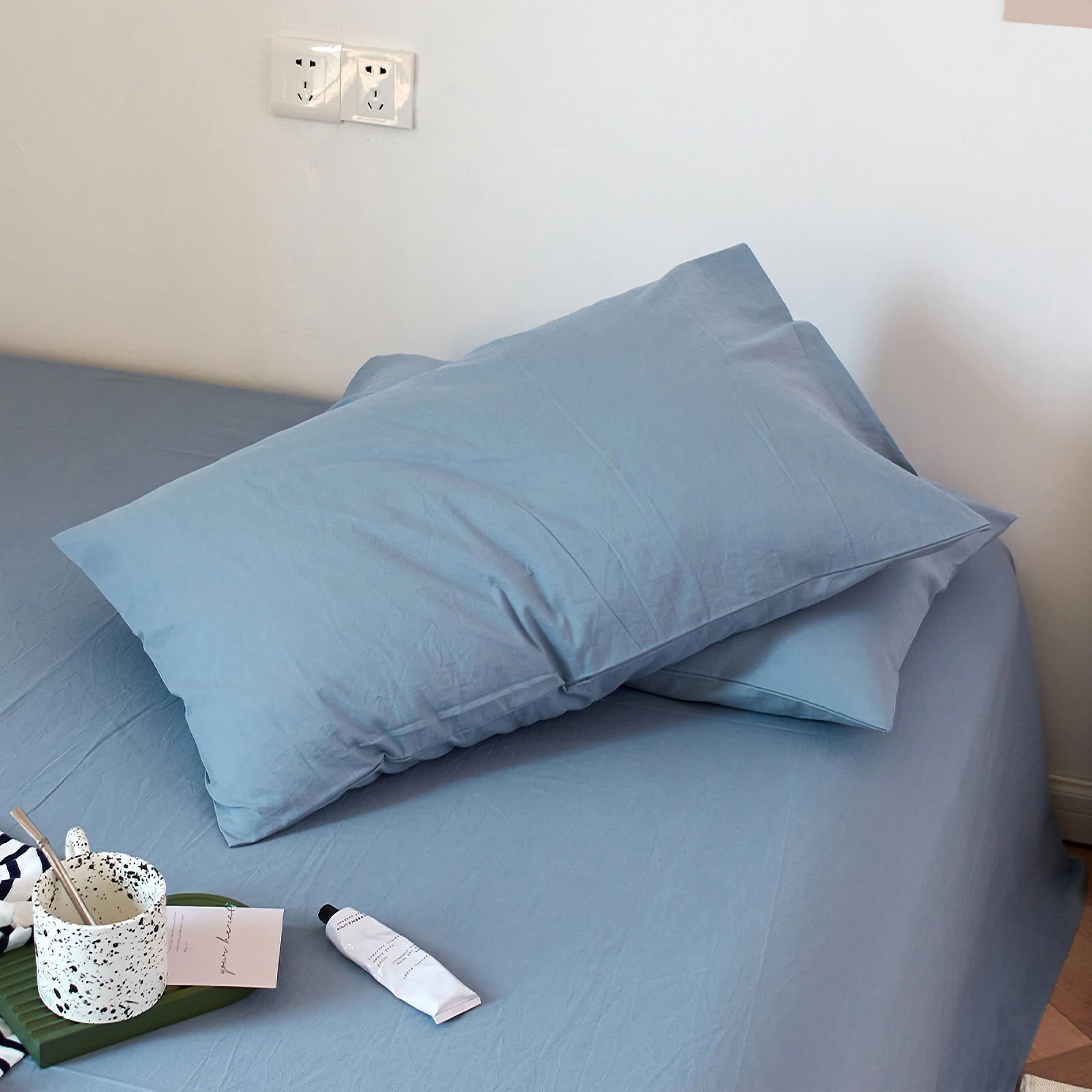 Soft washed cotton solid pillowcase in a minimalist cozy bedroom – RoomDen