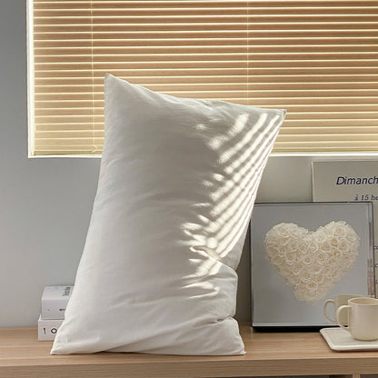 Soft washed cotton solid pillowcase in a minimalist cozy bedroom – RoomDen