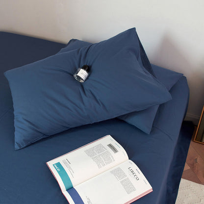 Soft washed cotton solid pillowcase in a minimalist cozy bedroom – RoomDen