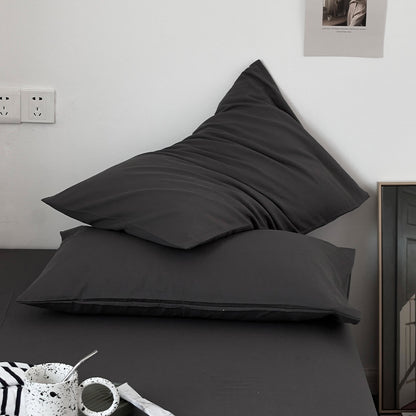 Soft washed cotton solid pillowcase in a minimalist cozy bedroom – RoomDen