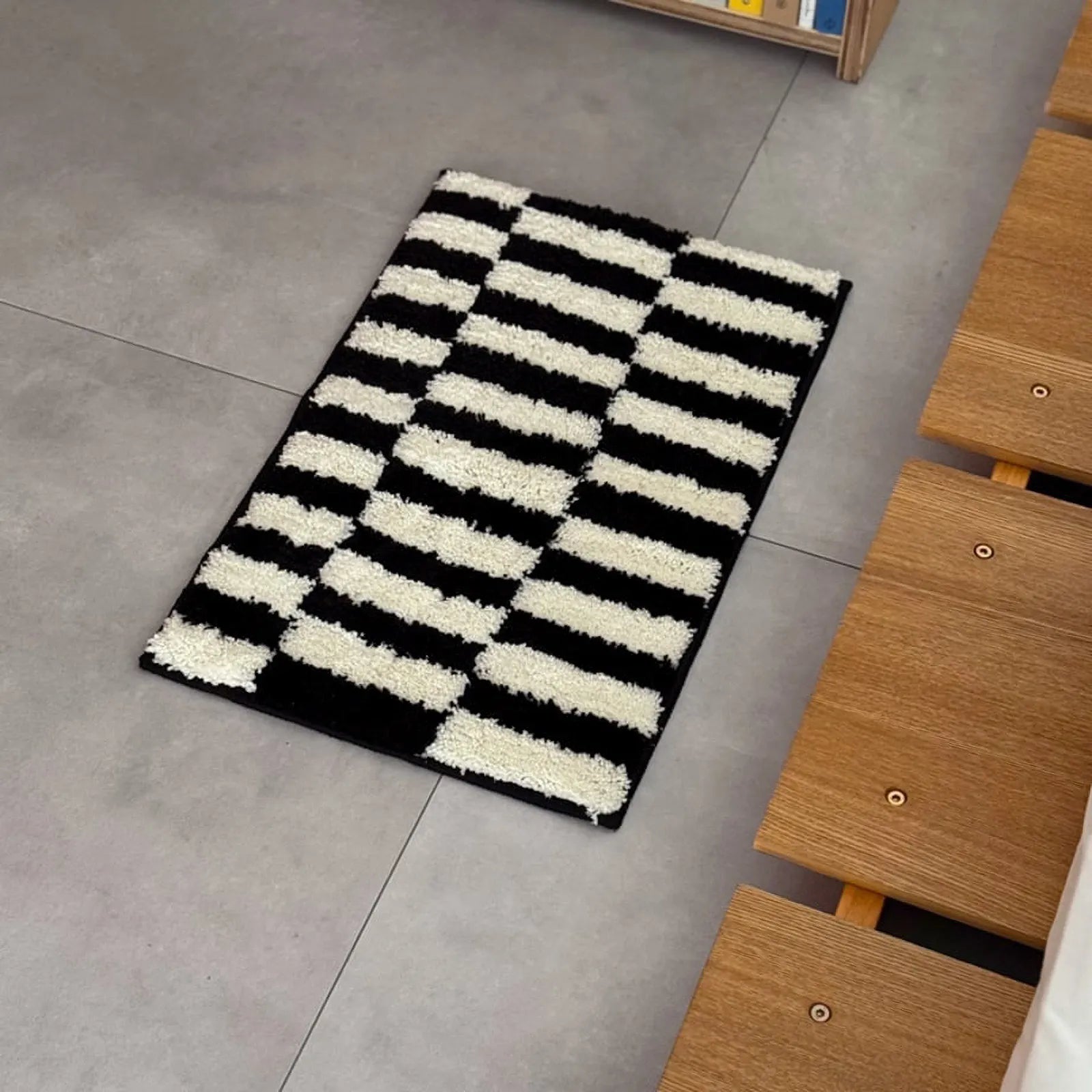 Close-up angle highlighting the thick plush pile of the black and white striped rug - RoomDen