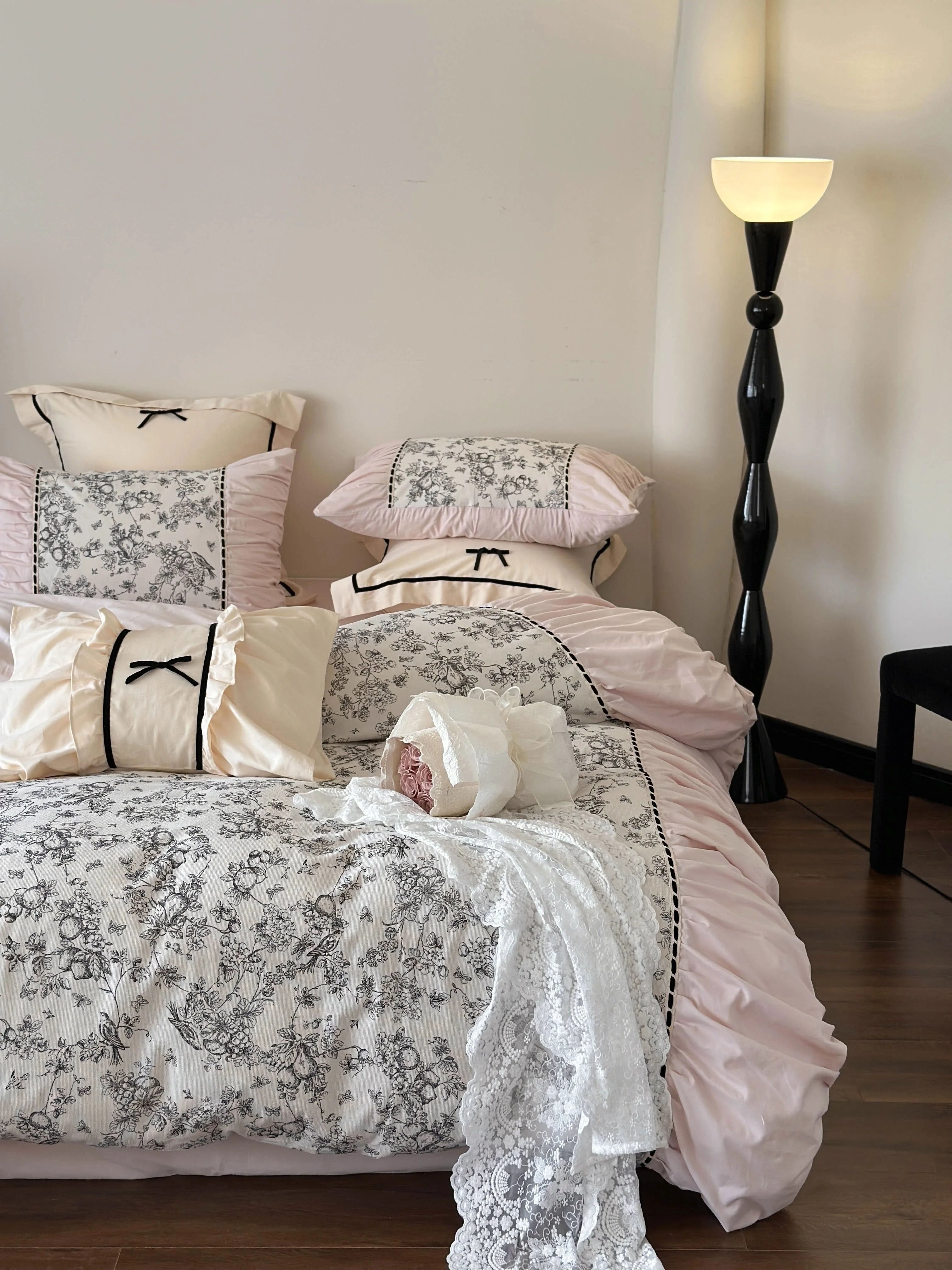 The Pink Toile bedding set styled with lace and a bouquet of roses, emphasizing the Coquette aesthetic. - RoomDen