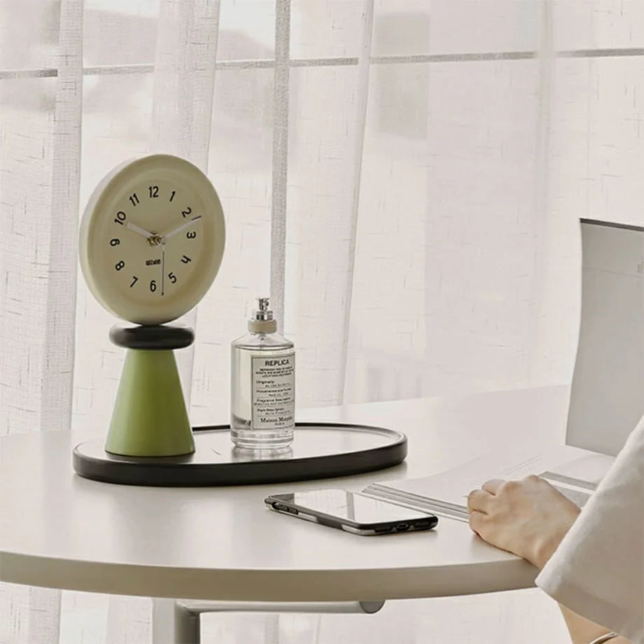Japandi-style green and beige table clock on a white desk next to a laptop. - RoomDen