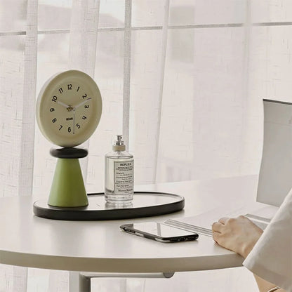 Japandi-style green and beige table clock on a white desk next to a laptop. - RoomDen