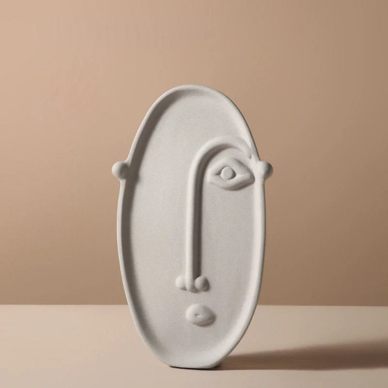 Front view of the minimalist oval-shaped face vase in a matte grey finish - RoomDen.
