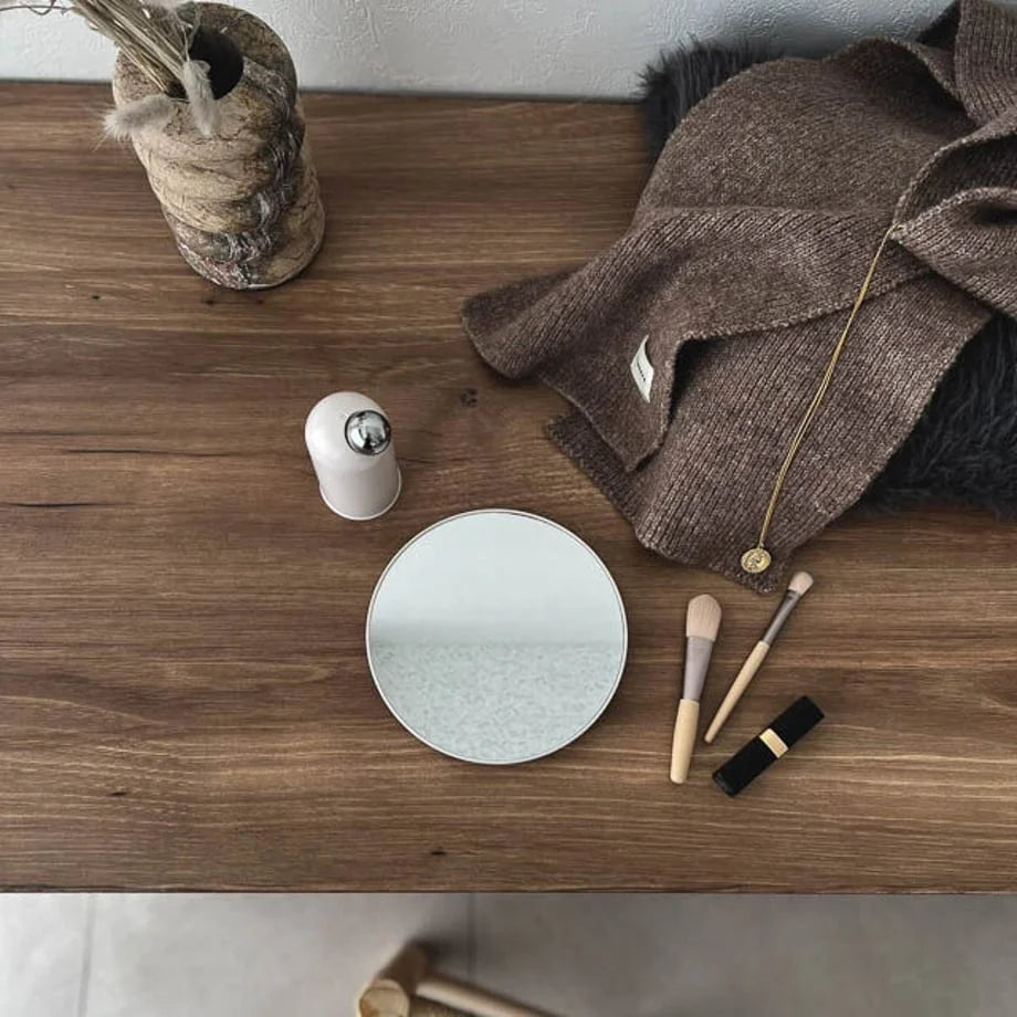 Top-down view of the white desktop mirror lying flat on a wooden surface.