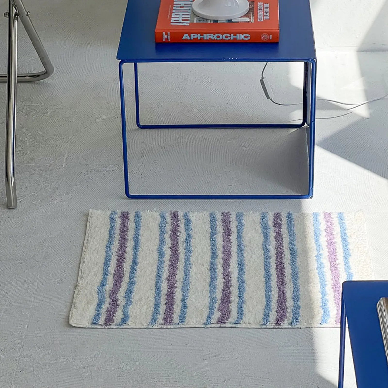 Top Down View of Rectangular White and Purple Striped Rug