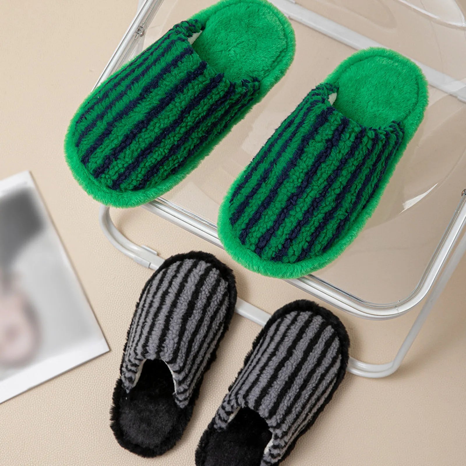 Green and Black striped plush slippers displayed on a modern acrylic chair - RoomDen
