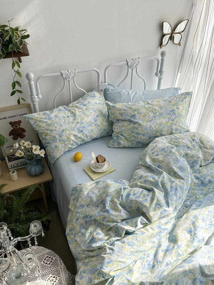 Light blue floral cotton bedding with lemon and cup on bedside table – RoomDen