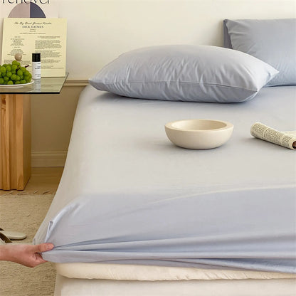 Solid washed cotton fitted sheet set in a minimalist bedroom – RoomDen