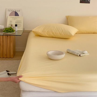 Solid washed cotton fitted sheet set in a minimalist bedroom – RoomDen