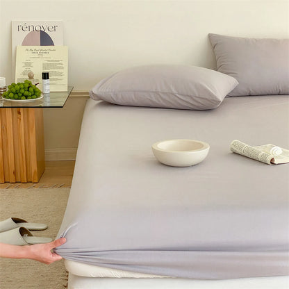 Solid washed cotton fitted sheet set in a minimalist bedroom – RoomDen