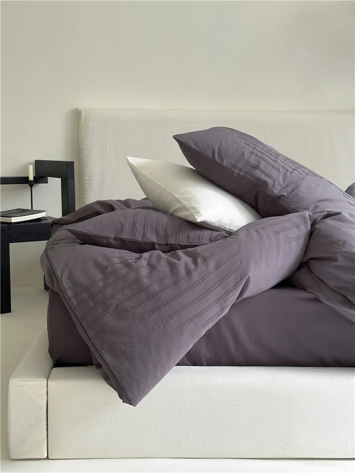 Minimalist textured stripe washed cotton pillowcase in soft neutral tones, styled in a calm cozy bedroom – RoomDen