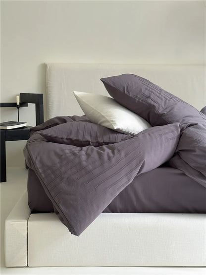 Minimalist textured stripe washed cotton pillowcase in soft neutral tones, styled in a calm cozy bedroom – RoomDen