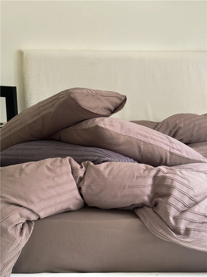 Minimalist textured stripe washed cotton pillowcase in soft neutral tones, styled in a calm cozy bedroom – RoomDen