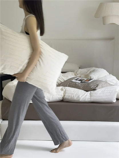 Minimalist textured stripe washed cotton pillowcase in soft neutral tones, styled in a calm cozy bedroom – RoomDen