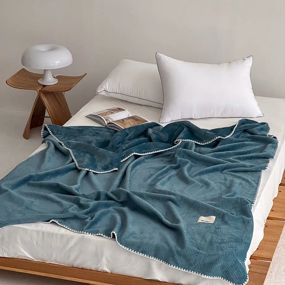 Soft waffle texture flannel fleece throw blanket in a minimalist cozy bedroom setting – RoomDen