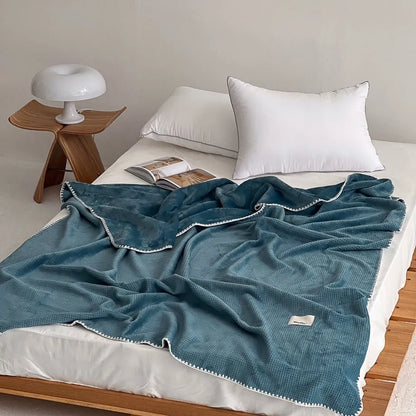 Soft waffle texture flannel fleece throw blanket in a minimalist cozy bedroom setting – RoomDen
