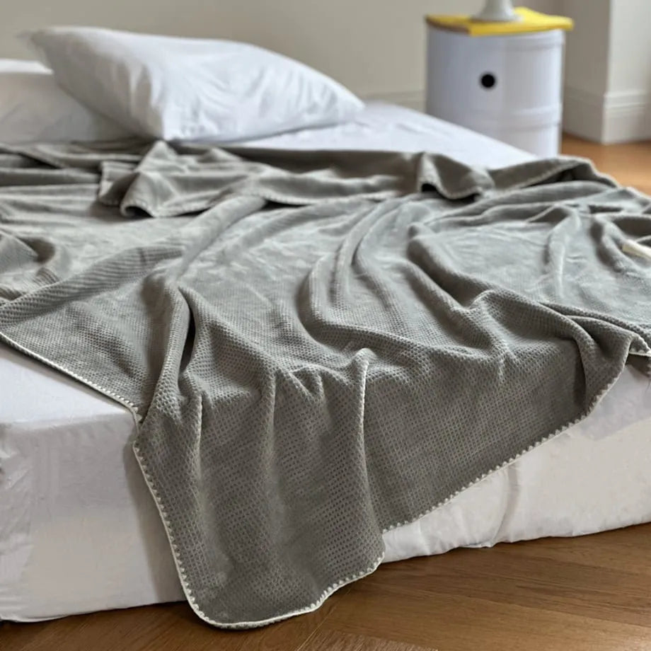 Soft waffle texture flannel fleece throw blanket in a minimalist cozy bedroom setting – RoomDen