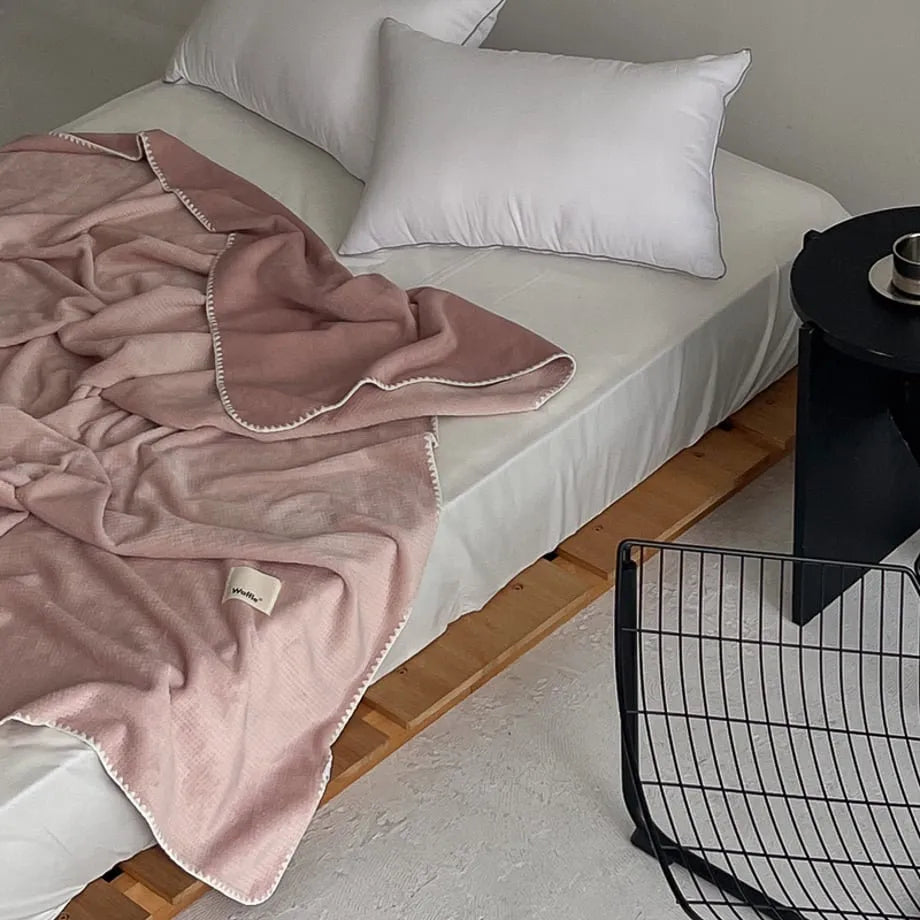 Soft waffle texture flannel fleece throw blanket in a minimalist cozy bedroom setting – RoomDen