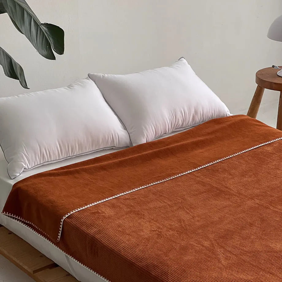 Soft waffle texture flannel fleece throw blanket in a minimalist cozy bedroom setting – RoomDen