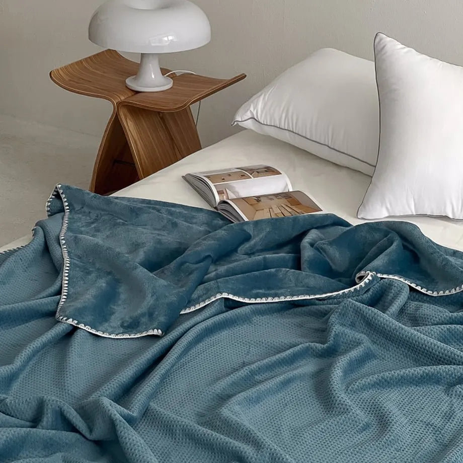 Soft waffle texture flannel fleece throw blanket in a minimalist cozy bedroom setting – RoomDen