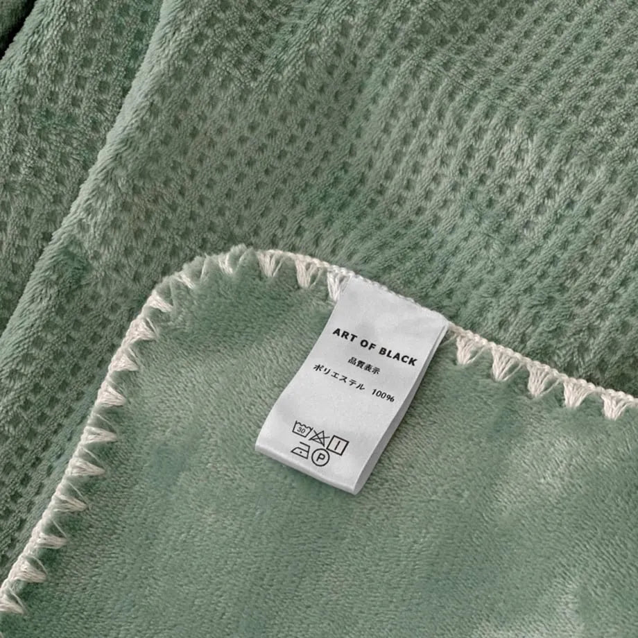 Soft waffle texture flannel fleece throw blanket in a minimalist cozy bedroom setting – RoomDen