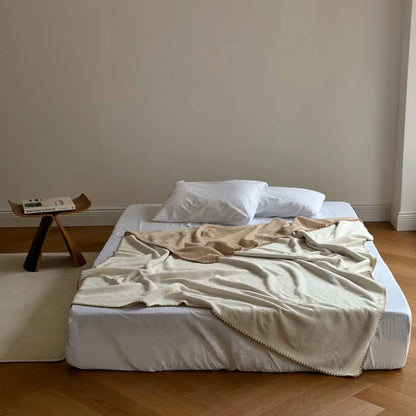 Soft waffle texture flannel fleece throw blanket in a minimalist cozy bedroom setting – RoomDen
