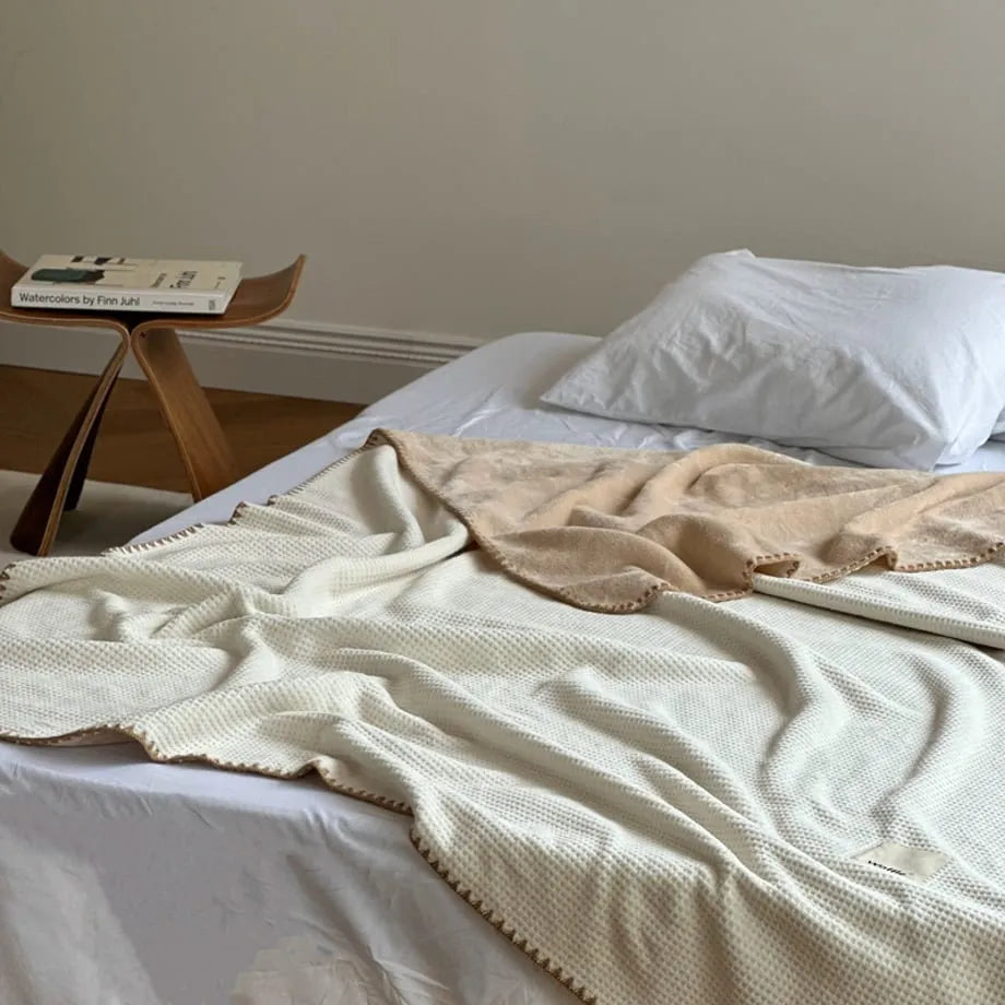 Soft waffle texture flannel fleece throw blanket in a minimalist cozy bedroom setting – RoomDen