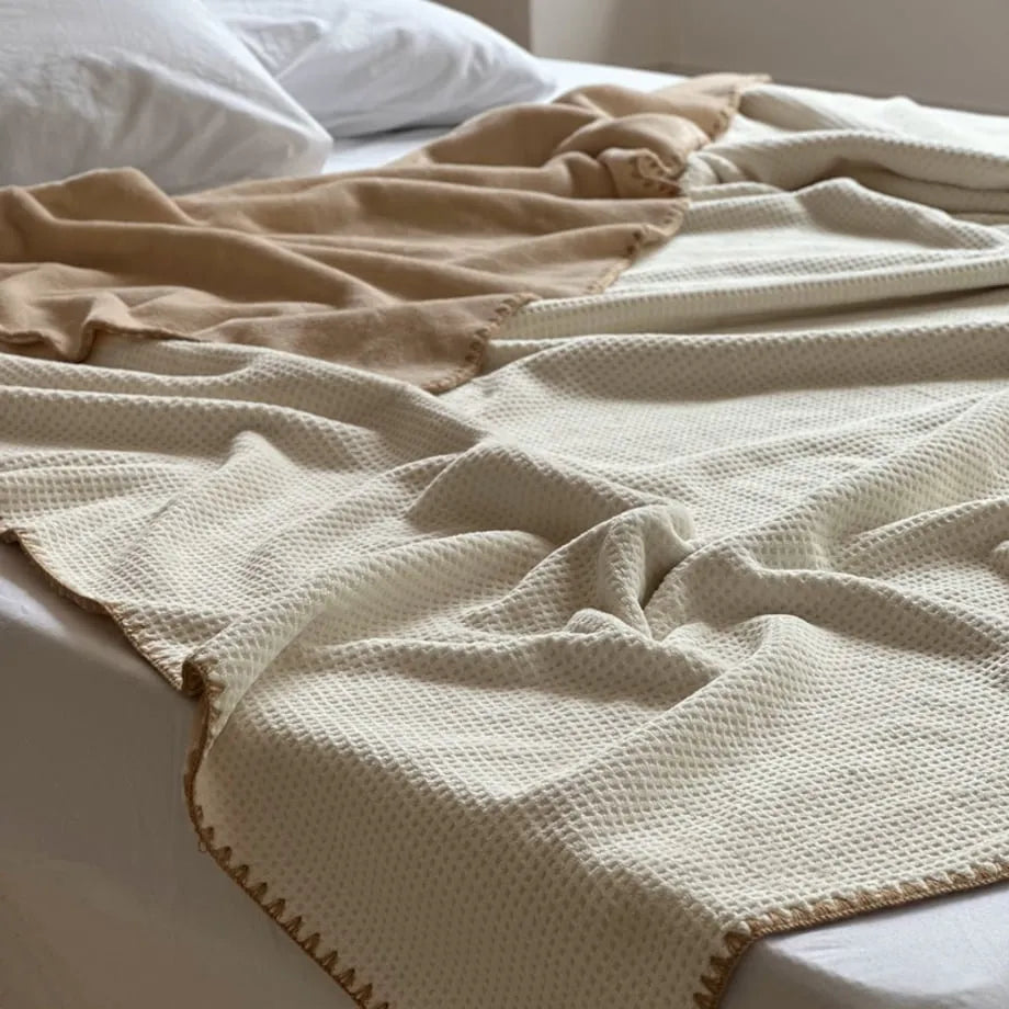 Soft waffle texture flannel fleece throw blanket in a minimalist cozy bedroom setting – RoomDen