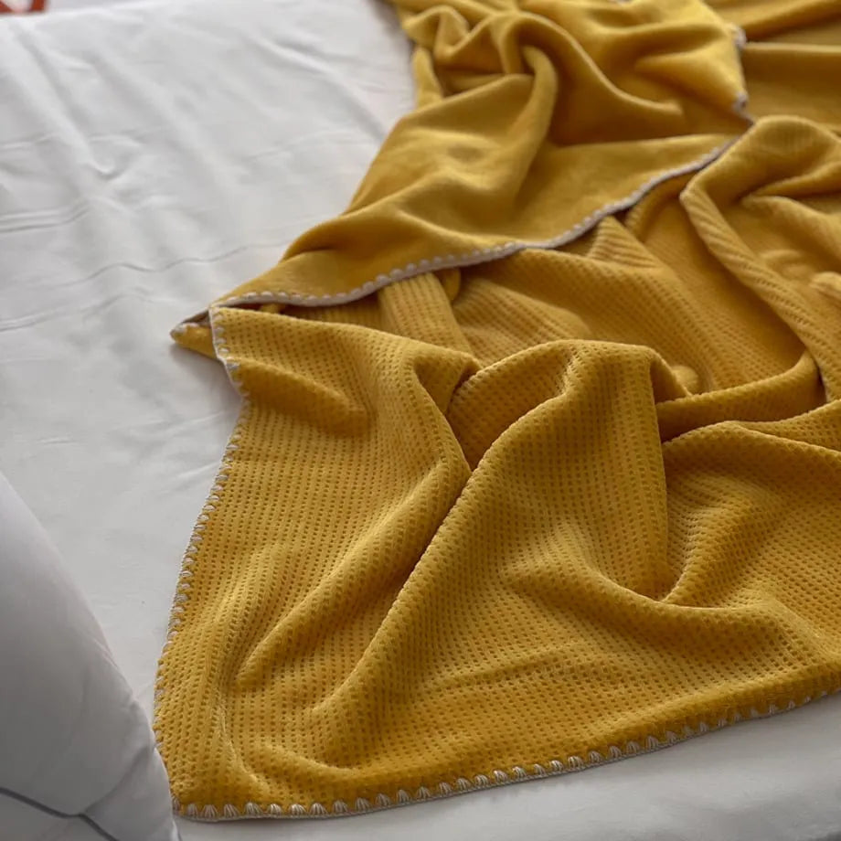 Soft waffle texture flannel fleece throw blanket in a minimalist cozy bedroom setting – RoomDen