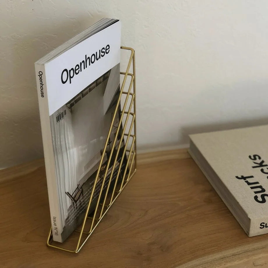 Gold Geometric Magazine Rack used as a freestanding holder on a wooden desk - RoomDen