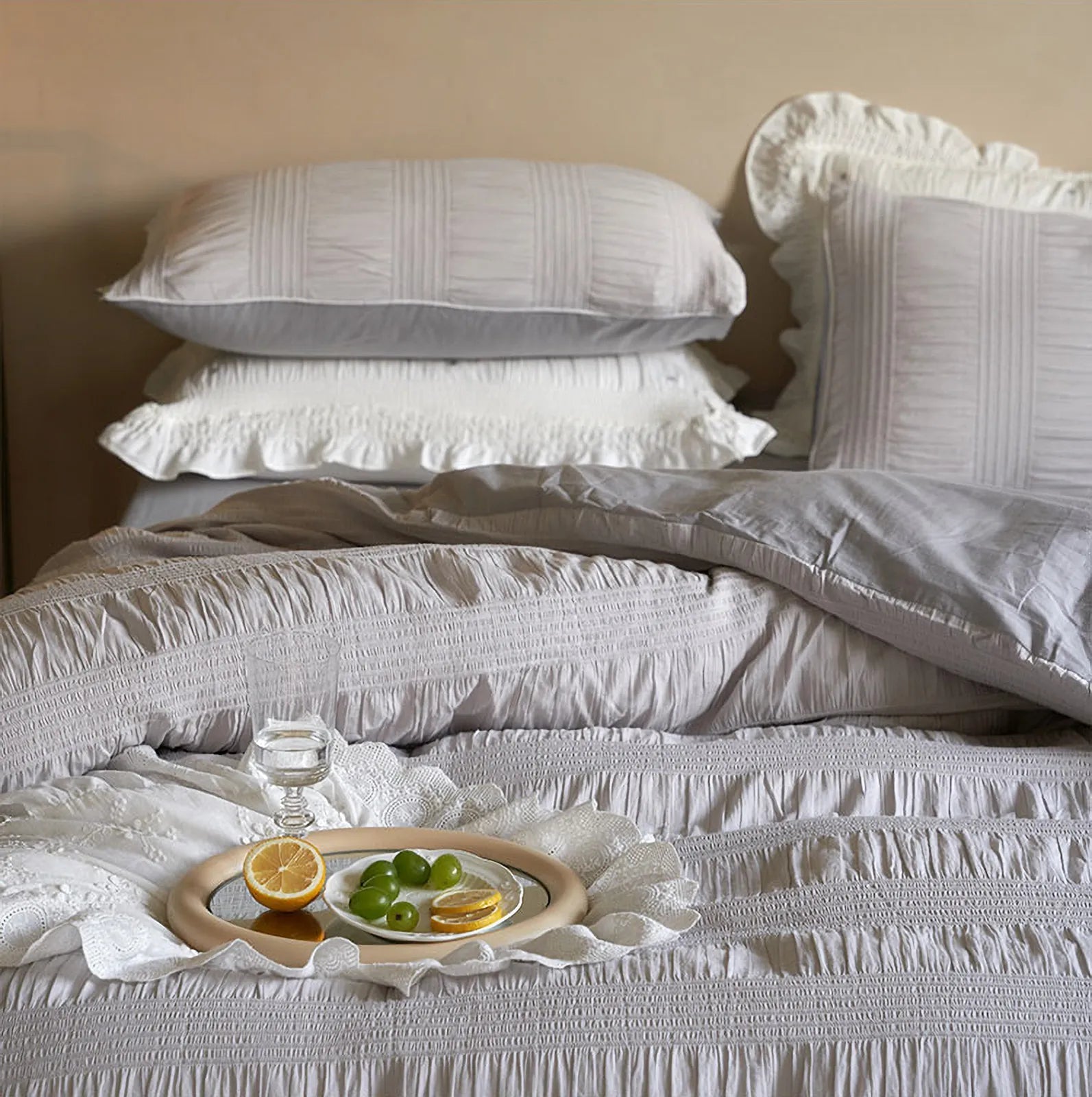 Dove Grey pintuck bedding with a decorative tray, highlighting the ruched texture.