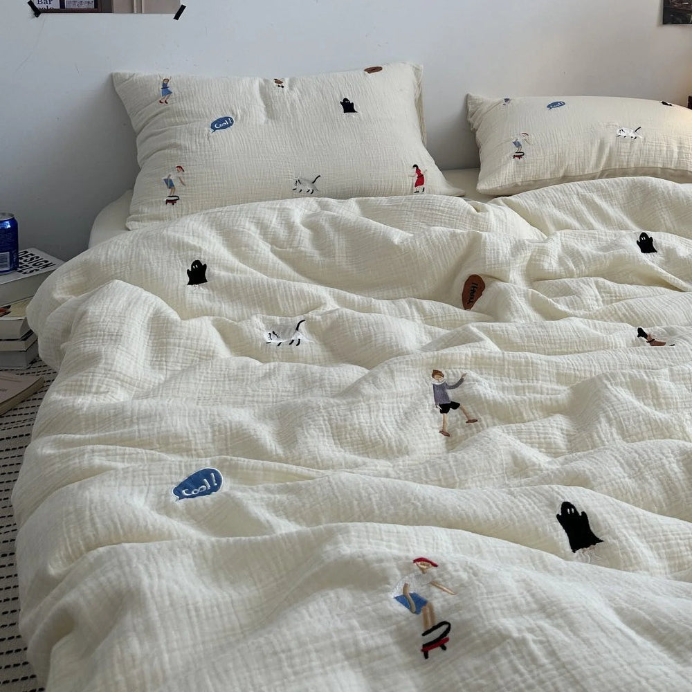 Textured cream washed cotton bedding set with whimsical embroidered characters, shown on a neatly made bed. - RoomDen